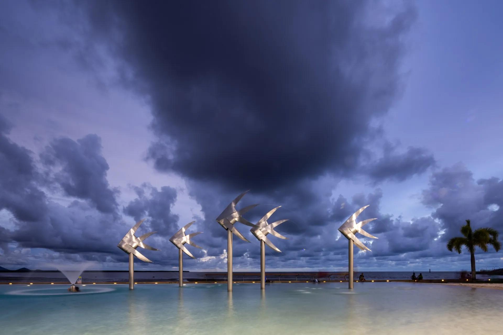 Wet season storm clouds building over the Cairns Esplanade Lagoon